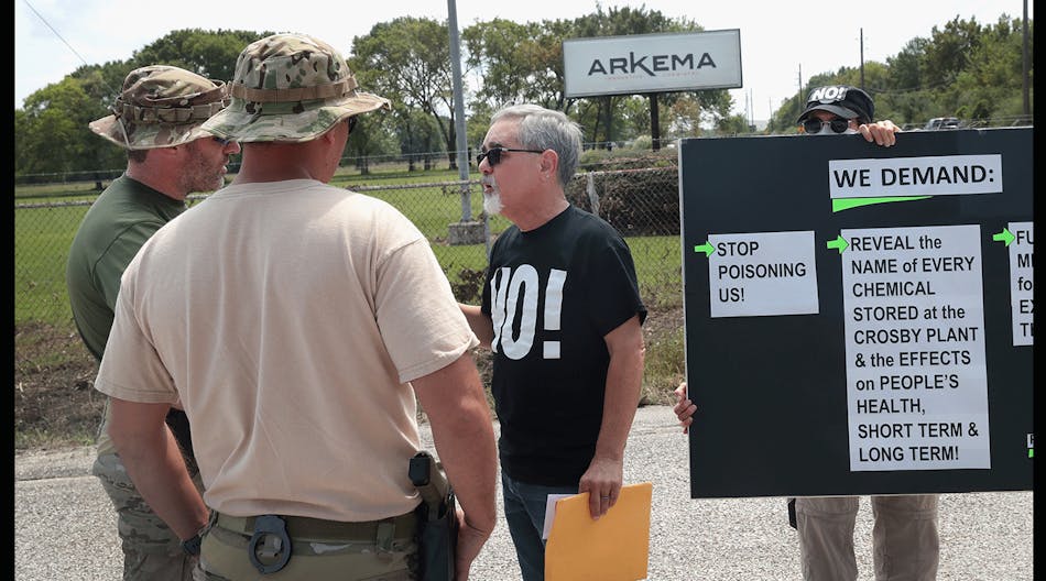 FBI agents confront protestors at the gate of the Arkema plant, which received major damage from flooding caused by Hurricane and Tropical Storm Harvey on Sept. 4 in Crosby, Texas. Authorities enacted an evacuation order for a 1.5-mile perimeter around th